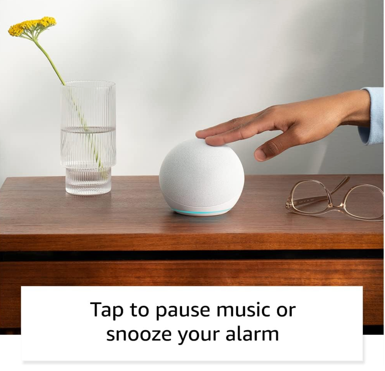 Amazon Echo Dot smart speaker in charcoal color placed on a wooden surface, Echo Dot streaming music from Amazon Music, Spotify, and more